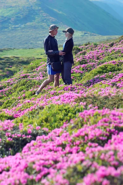 Couple in love among the flowers — Stock Photo, Image