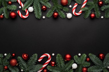 Kırmızı Noel şablonu, siyah arka planda Noel topları ve şeker kamışlı şablonu.