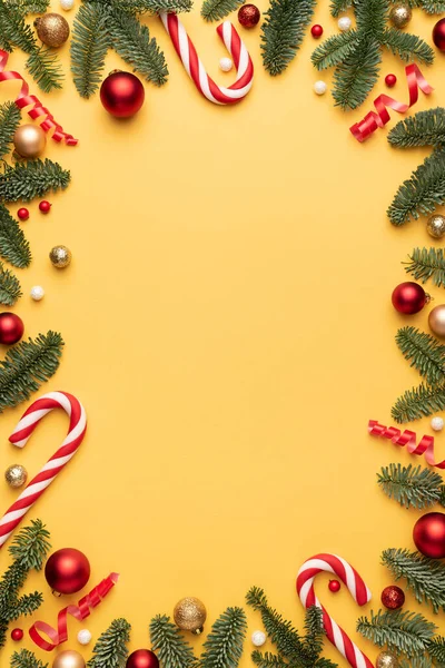 Christmas card with holiday frame on yellow background. Flat lay, top view and copy space for text