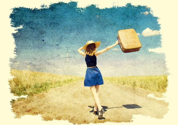 Lonely girl with suitcase at country road. — Stock Photo, Image