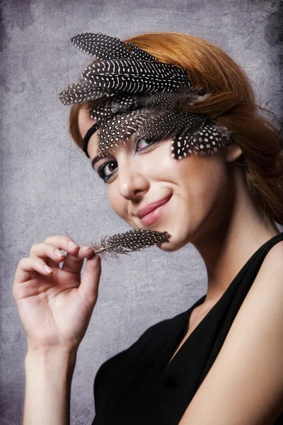 Redhead girl with feathers on the head — Stock Photo, Image