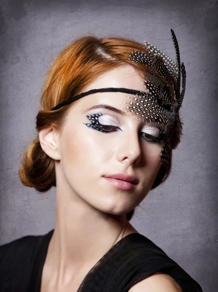 Redhead girl with feathers on the head — Stock Photo, Image