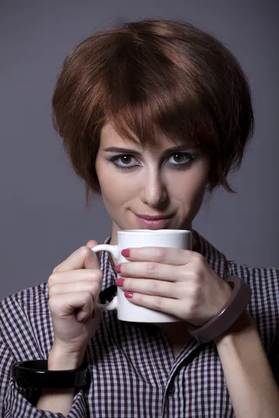 Style girl in shirt with cup at studio. — Stock Photo, Image