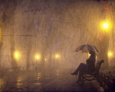 Geceleri tezgah otururken şemsiye ile tek kız.