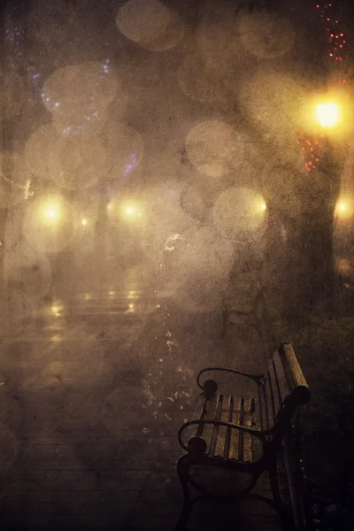 Bench in night alley with lights in Odessa, Ukraine. Photo in re — Stock Photo, Image