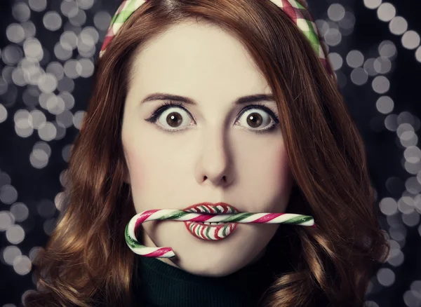 Beautiful surprised women with Christmas candy.