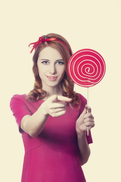 Beautiful redhead girl with lollipop. Photo in retro style. — Stock Photo, Image