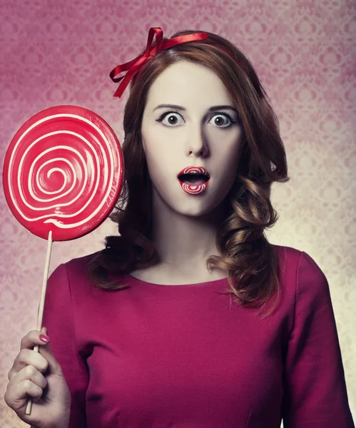 Beautiful redhead girl with lollipop. Photo in retro style. — Stock Photo, Image