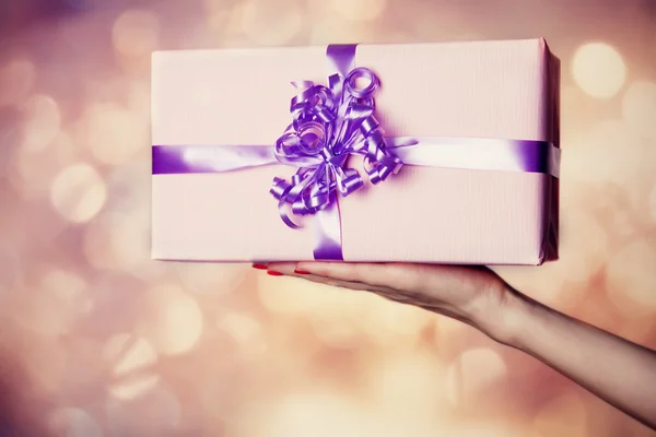 Female hand holding gift. — Stock Photo, Image