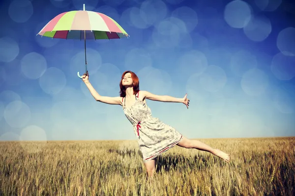 Girl with umbrella at field — Stock Photo, Image