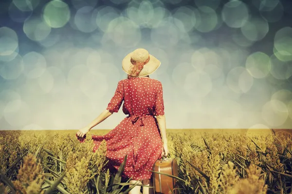 Redhead girl with suitcase at corn field. — Stock Photo, Image