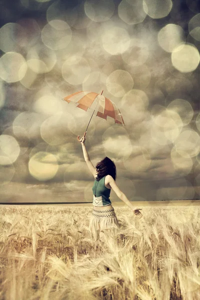 Mädchen am Weizenfeld mit Regenschirm. — Stockfoto