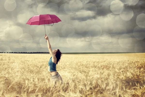Girl at wheat field with umbrella. — Stock Photo, Image