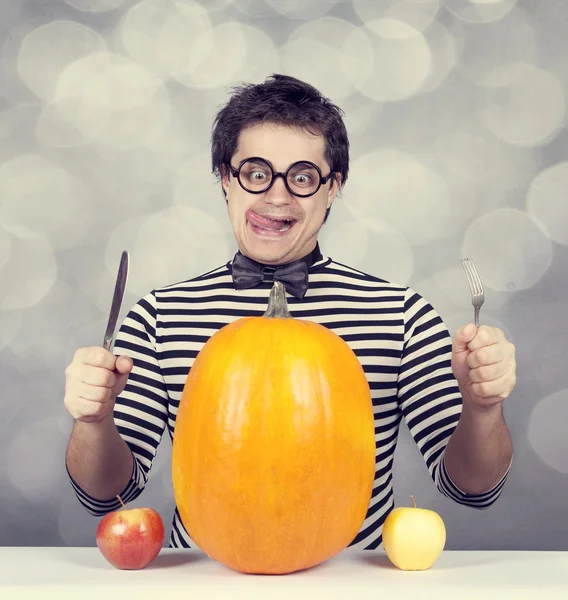 De unga galna män försöker äta två äpplen och pumpa. — Stockfoto