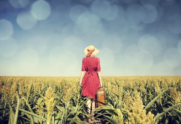 Redhead girl with suitcase at corn field. — Stock Photo, Image