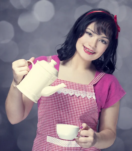 Brunette women with teapot and cup. — Stock Photo, Image