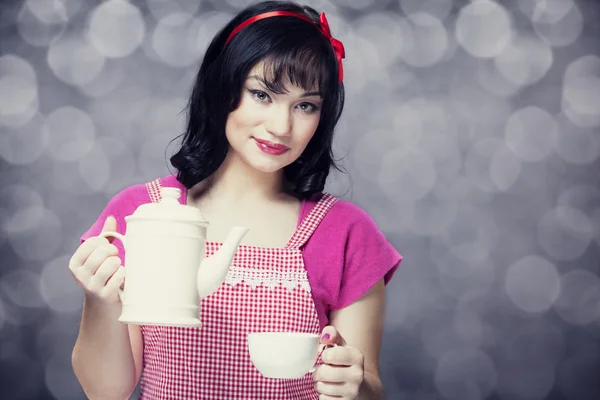 Brunette women with teapot and cup. — Stock Photo, Image