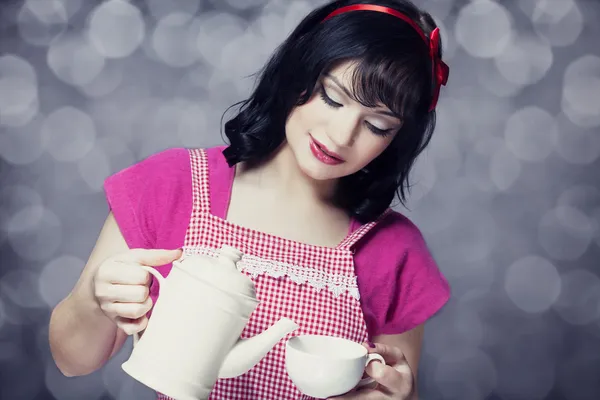 Brunette women with teapot and cup. — Stock Photo, Image