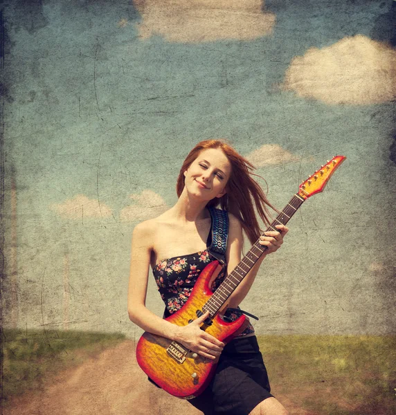 Red-head girl with guitar. Photo in old image style. — Stock Photo, Image
