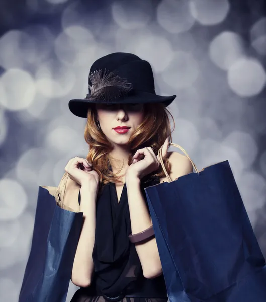 Style redhead girl with shopping bags. — Stock Photo, Image