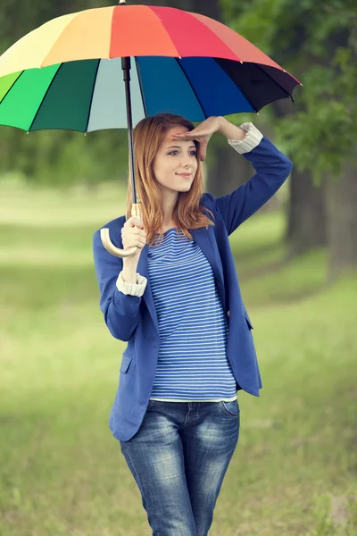 Young fashion girl with umbrella at spring outdoor. — Stock Photo, Image