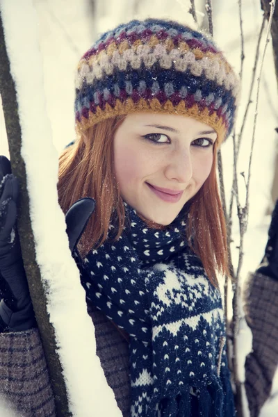 Beautiful young red-haired woman in winter park — Stock Photo, Image