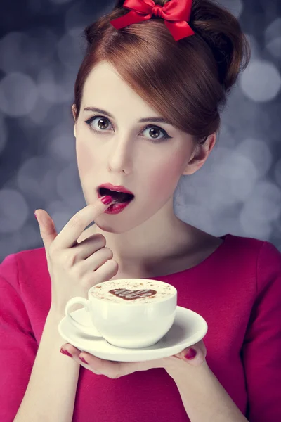 Redhead girl with cup of coffee for St. Valentine Stock Image