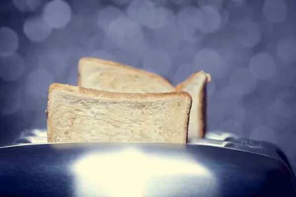 Close-up shot of a bread toast in a toaster — Stock Photo, Image
