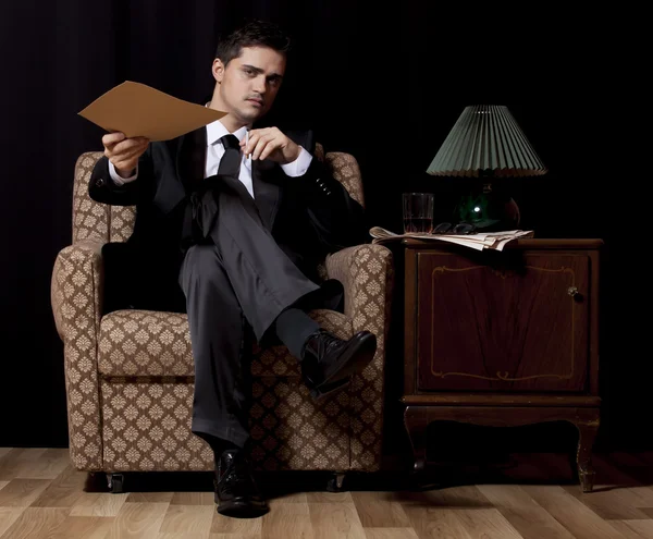 Man with file sitting in vintage armchair — Stock Photo, Image