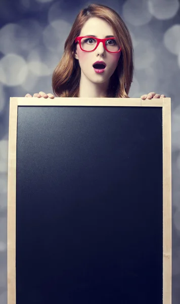 Redhead student with blackboard. — Stock Photo, Image