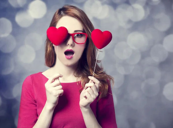 Beautiful redhead girl with two hearts. — Stock Photo, Image