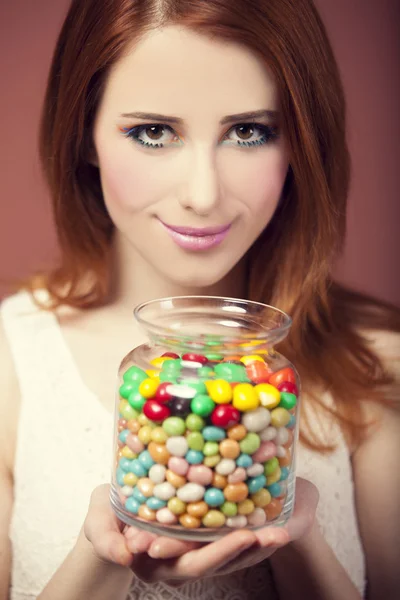 Young woman holding a bowl full of jelly beans — Stock Photo, Image