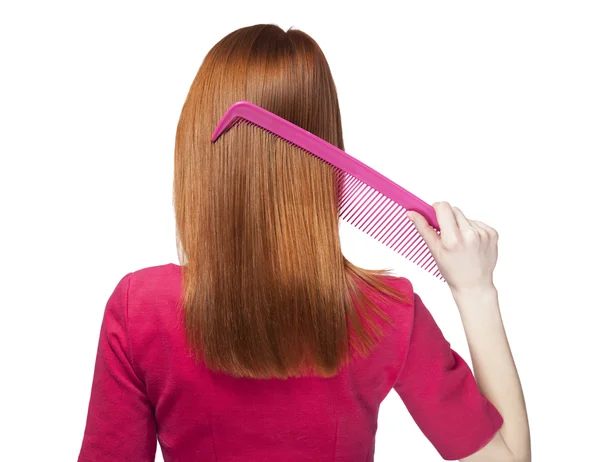 Redhead girl with big comb — Stock Photo, Image