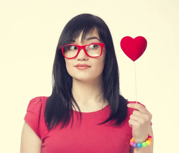 Beautiful girl with toy heart. — Stock Photo, Image