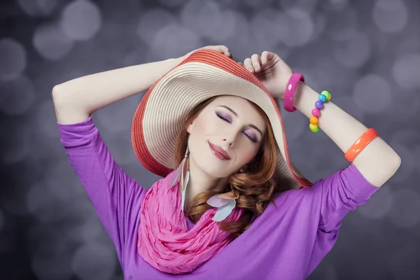 Beautiful red-haired girl in hat at bokeh background — Stock Photo, Image