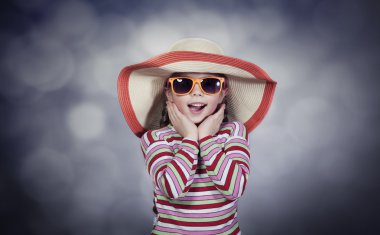 Happy summery girl wearing a hat and sunglasses