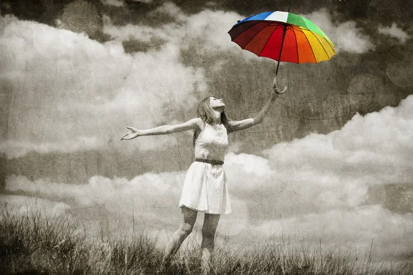 Beautifu girl with umbrella and suitcase at sky background. — Stock Photo, Image