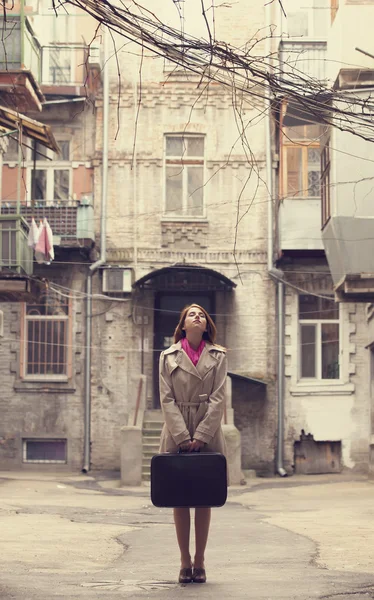 Redhead girl on the yard with suitcase in Odessa. — Stock Photo, Image