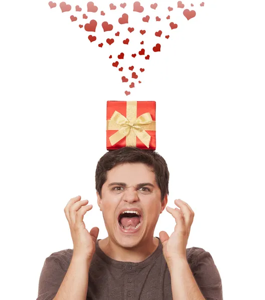 An angry man holding present box on white background. — Stock Photo, Image