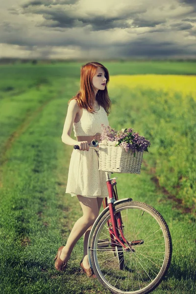 Girl on a bike in the countryside — Stock Photo, Image