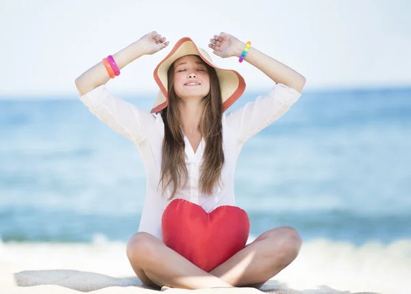 Closeup of pretty young smiling woman with toy heart — Stock Photo, Image