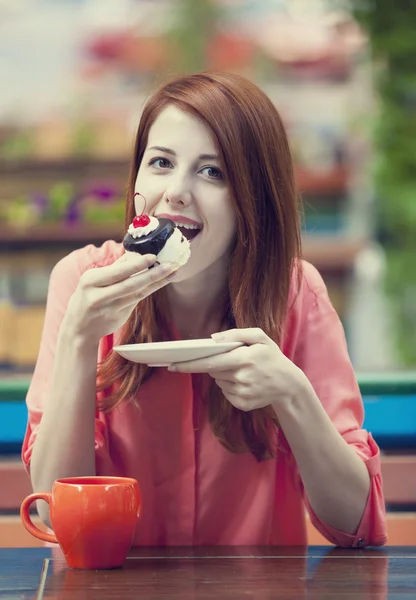 Style redhead girl with cake and cup — Stock Photo, Image