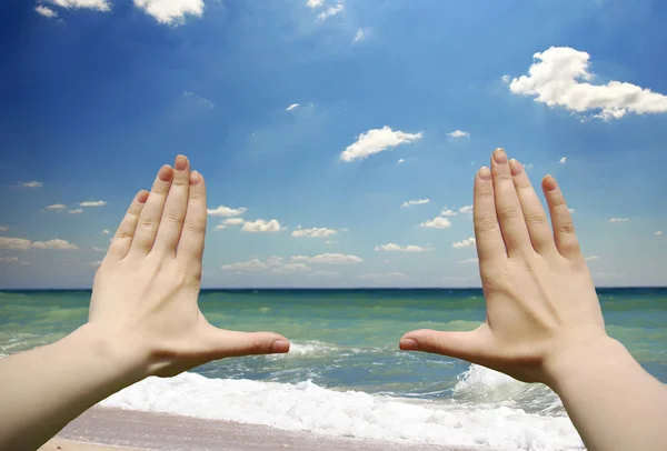 Hands frame over beach background — Stock Photo, Image