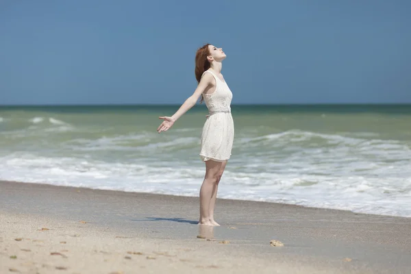 Redhead girl on the beack in spring time — Stock Photo, Image