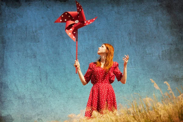 Girl with wind turbine at field — Stock Photo, Image