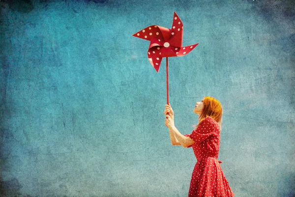 Girl with wind turbine at field — Stock Photo, Image