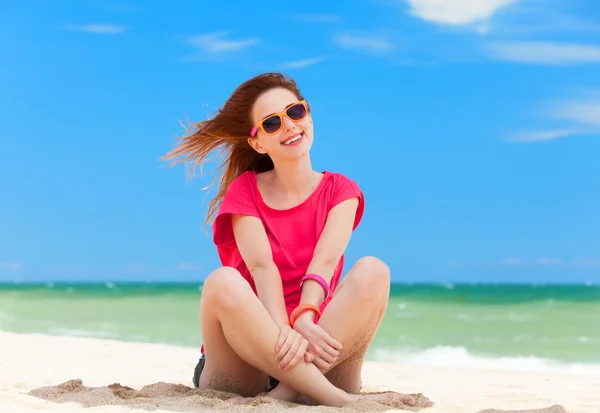 Divertido adolescente chica sentada en la arena en la playa . —  Fotos de Stock