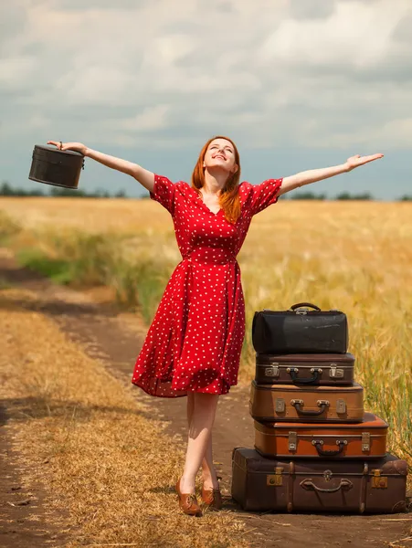 Redhead girl with suitcases at outdoor. — Stock Photo, Image