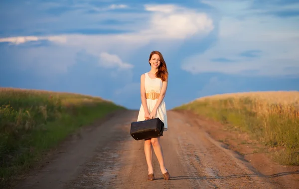 Redhead girl with suitcase at outdoor. — Stock Photo, Image