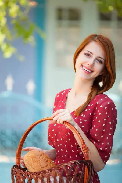 Redhead girl in red dress at outdoor near old house — Stock Photo, Image